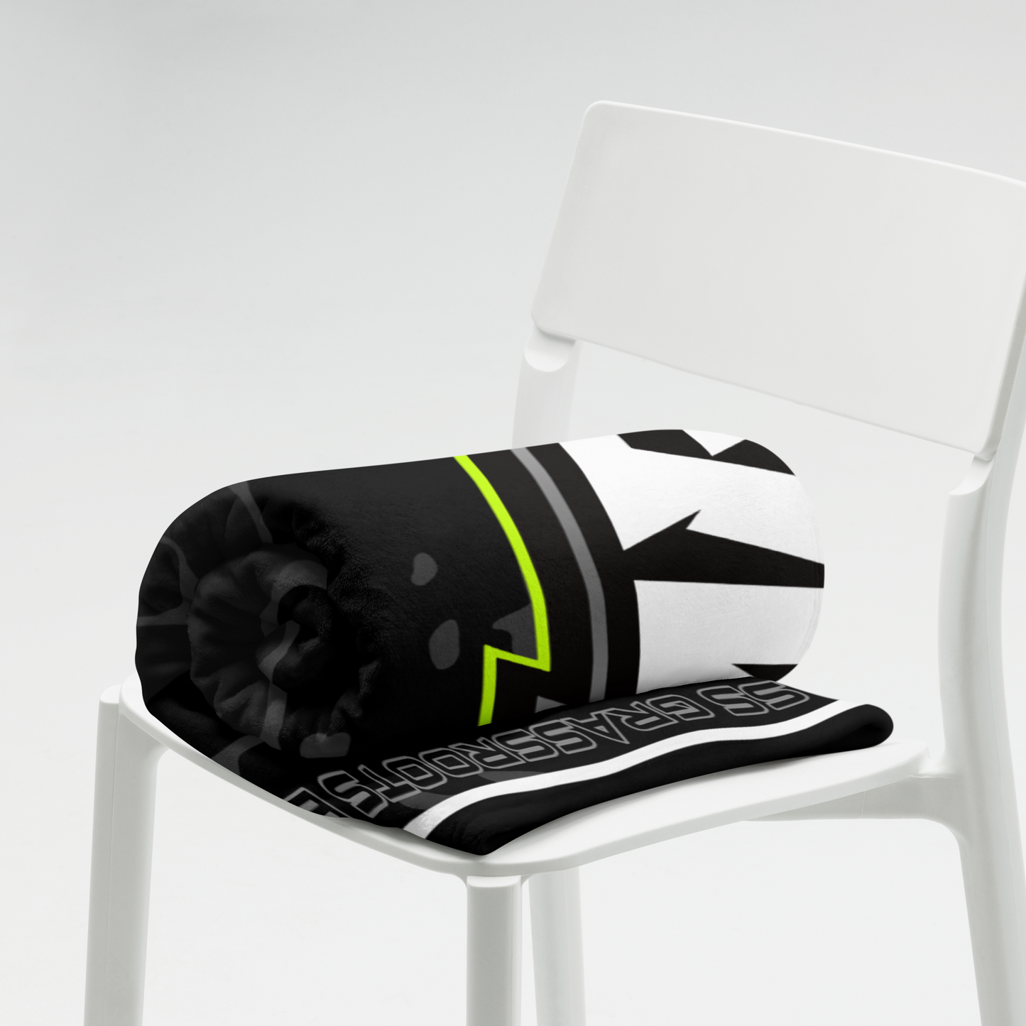 Black and white cushion with a green stripe on a white chair